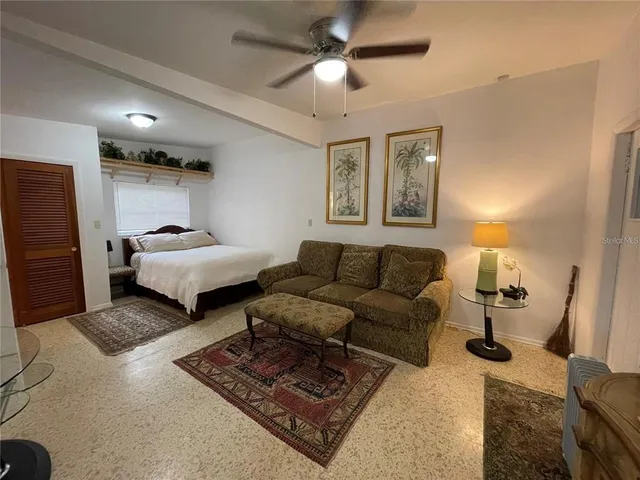 a living room with furniture and a lamp