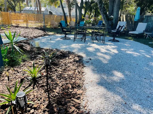 a view of backyard with sitting area