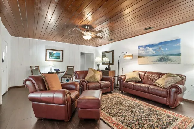 a living room with furniture ceiling fan and a rug