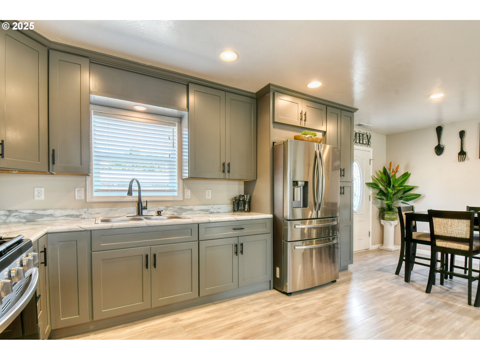 256 Northwest Jewell Court Irrigon, OR 97844 - Photo 11 of 47 a kitchen with stainless steel appliances a sink and a refrigerator
