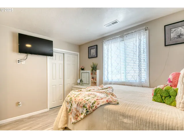 a bedroom with a bed and a flat screen tv