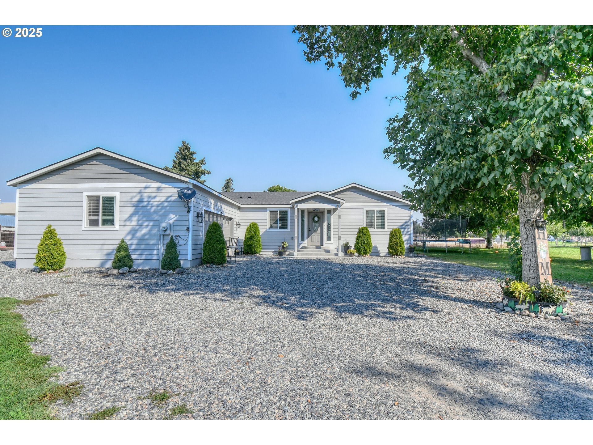 256 Northwest Jewell Court Irrigon, OR 97844 - Photo 19 of 47 a front view of a house with a garden