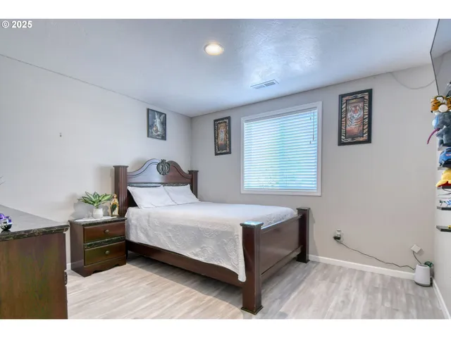 a bedroom with a bed and a night stand