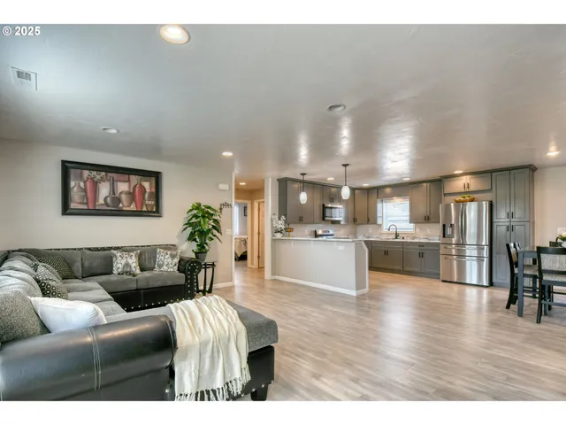 a living room with furniture and kitchen view