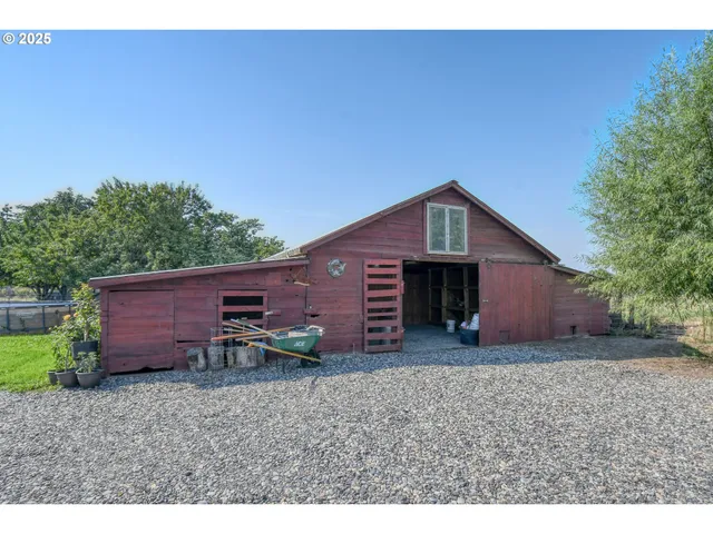a view of a house with a yard and wooden fence