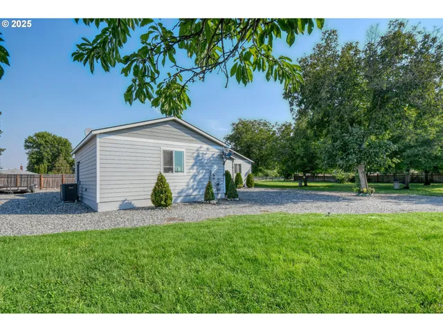 a backyard of a house with yard and outdoor seating