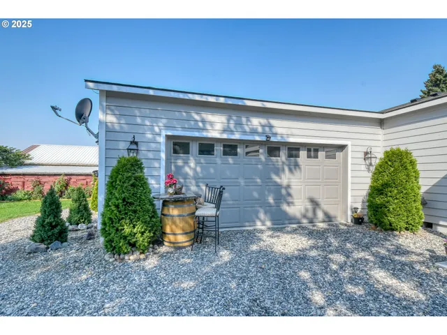 a view of a porch with furniture and garden