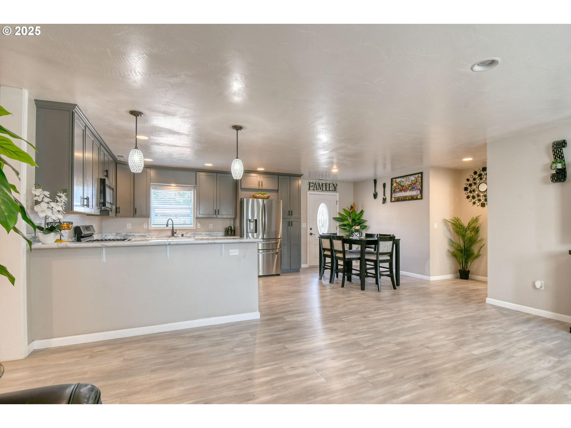 256 Northwest Jewell Court Irrigon, OR 97844 - Photo 5 of 47 a kitchen with stainless steel appliances kitchen island granite countertop a table and chairs