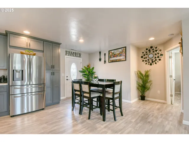 a kitchen with furniture and refrigerator