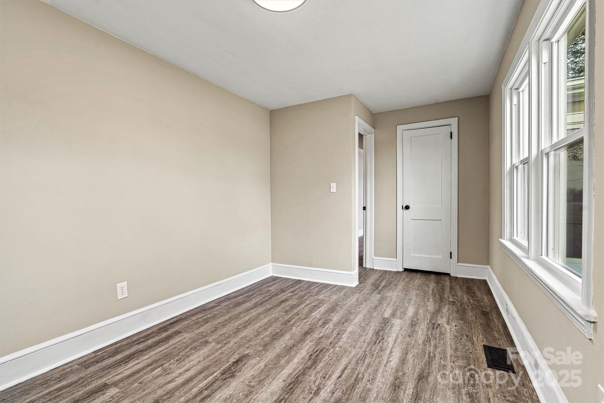 2829 1st Avenue Northwest Hickory, NC 28601 - Photo 12 of 22 a view of an empty room with wooden floor and a window