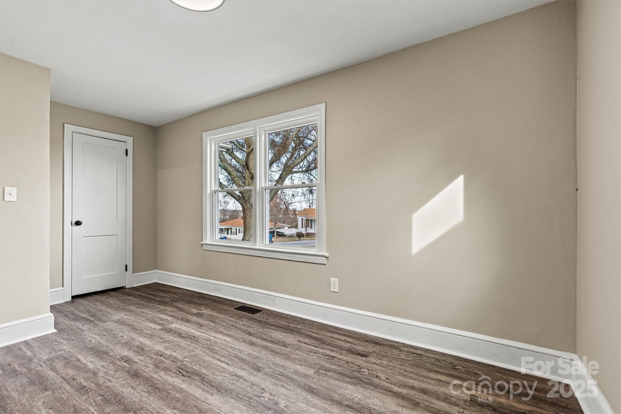 2829 1st Avenue Northwest Hickory, NC 28601 - Photo 13 of 22 wooden floor in an empty room with a window