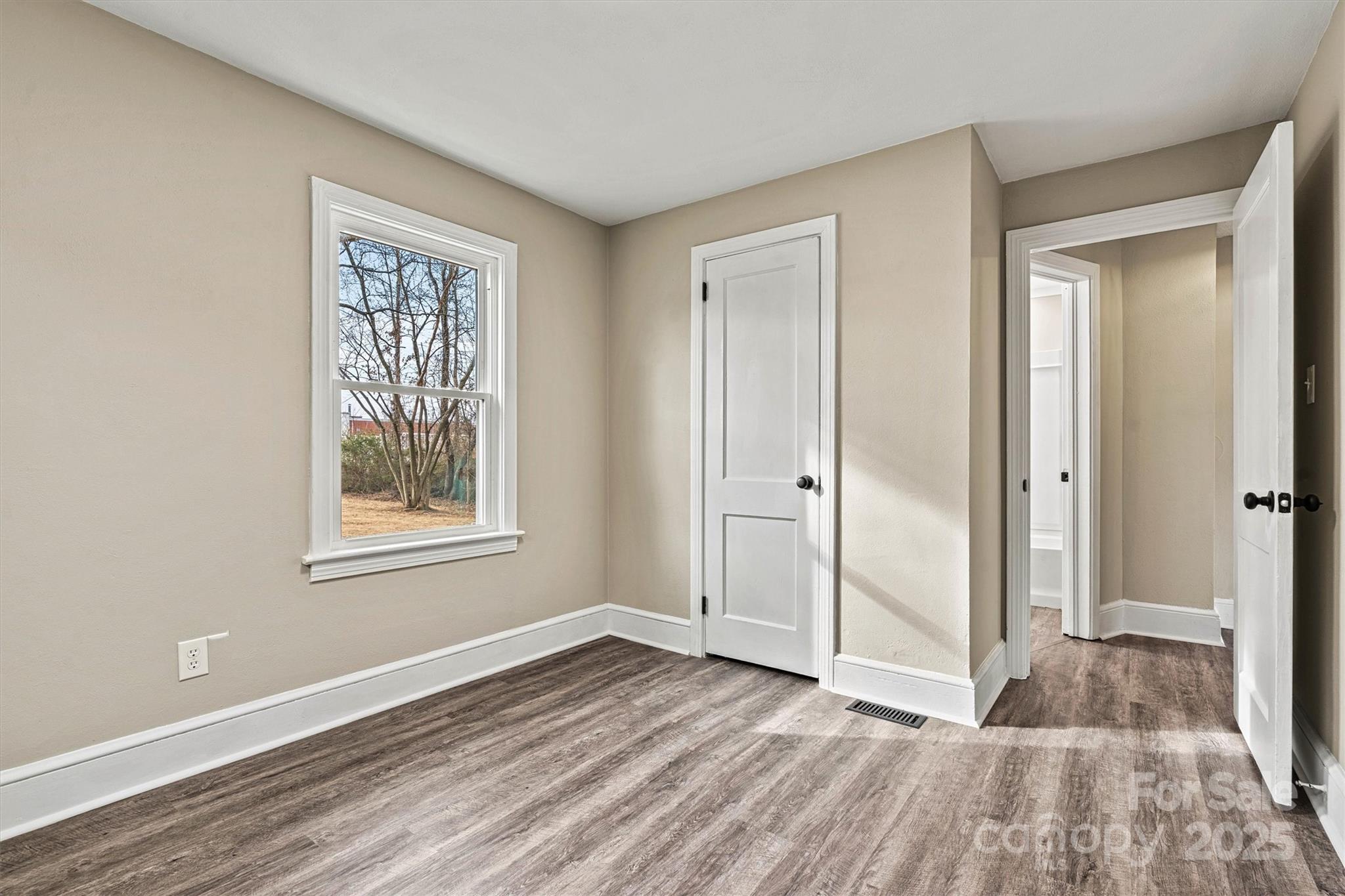 2829 1st Avenue Northwest Hickory, NC 28601 - Photo 14 of 22 an empty room with wooden floor and windows