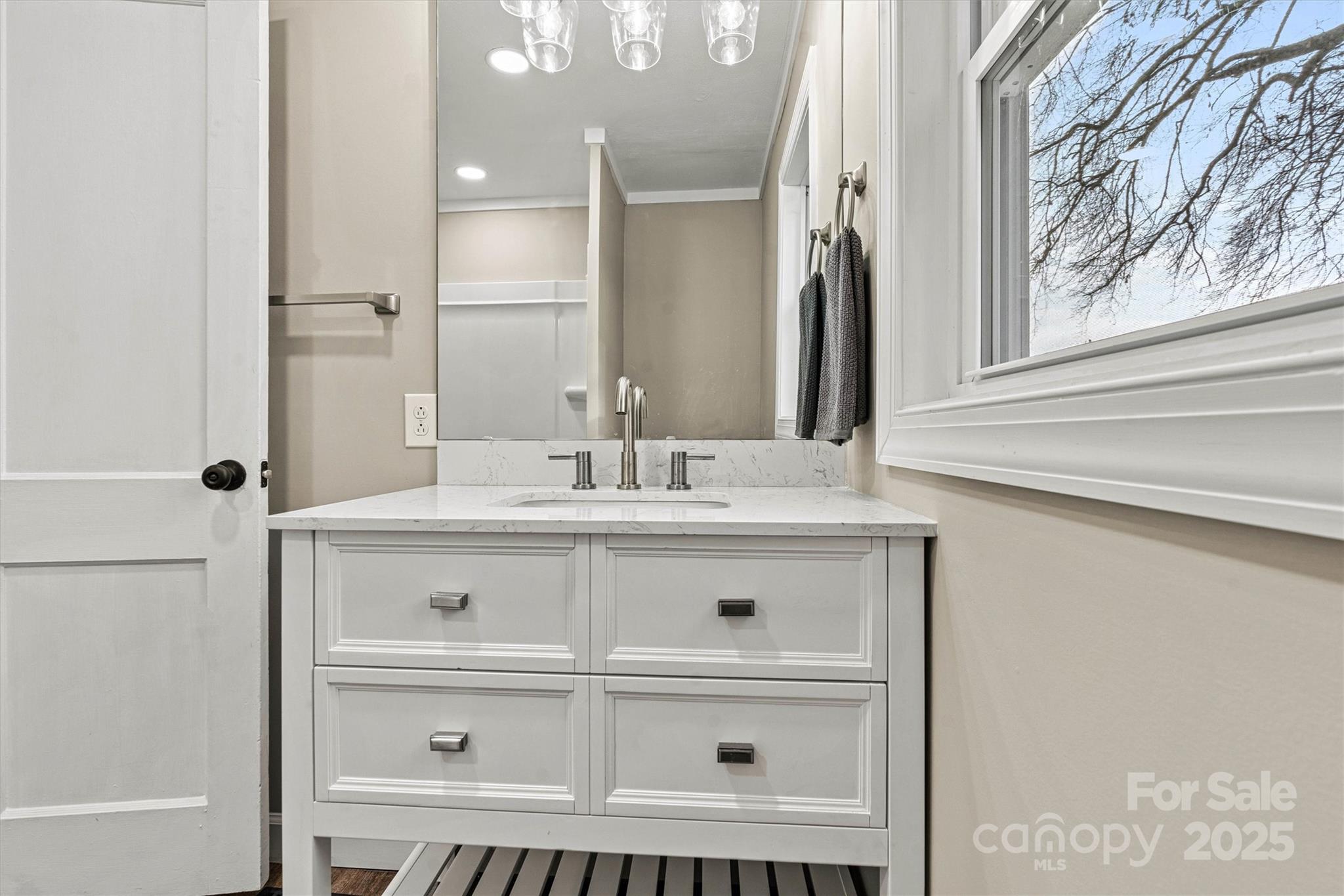 2829 1st Avenue Northwest Hickory, NC 28601 - Photo 9 of 22 a bathroom with a sink a vanity and a mirror