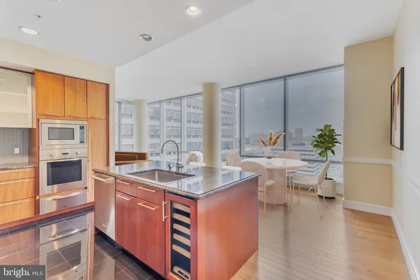 a kitchen with stainless steel appliances granite countertop a stove a sink and a refrigerator