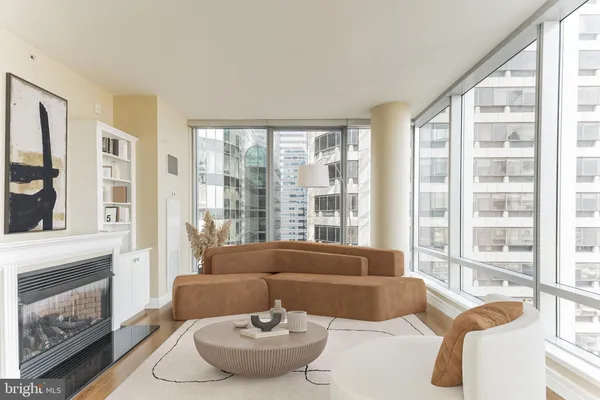 a living room with furniture and a floor to ceiling window