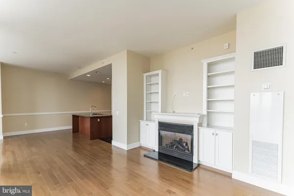 a view of a livingroom with a fireplace and cabinet