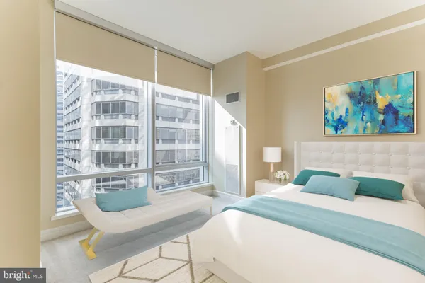 a bedroom with a large bed and a window