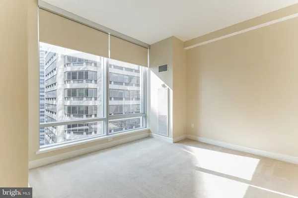 a view of an empty room with glass windows