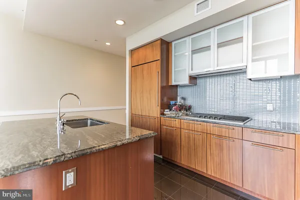 a kitchen with granite countertop a sink and cabinets