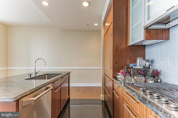 a kitchen with stainless steel appliances granite countertop a sink and a stove