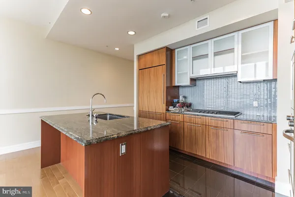 a kitchen with stainless steel appliances granite countertop a sink a stove and a refrigerator