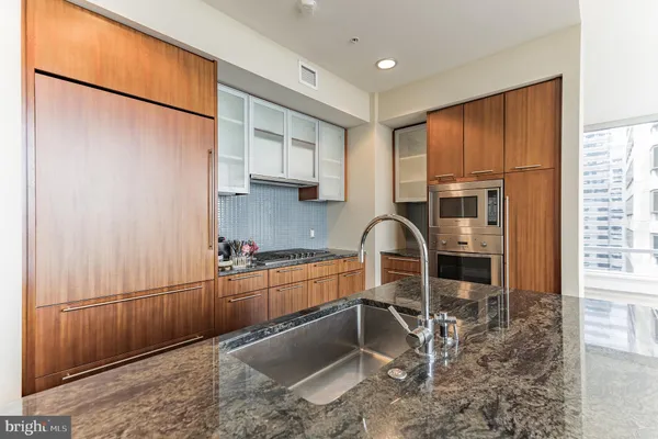 a kitchen with stainless steel appliances granite countertop a refrigerator sink and cabinets