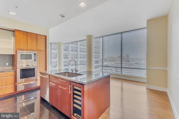 a kitchen with stainless steel appliances granite countertop a stove and a wooden cabinets