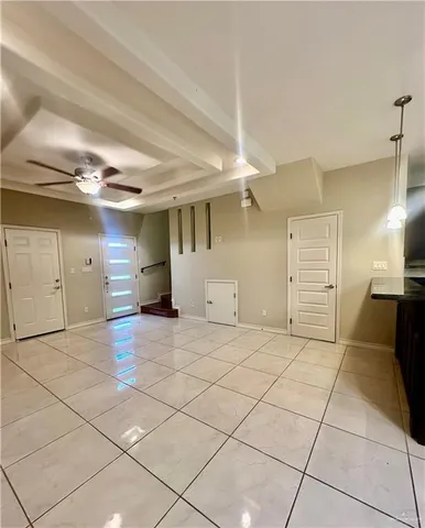 a large kitchen with granite countertop a stove and cabinets