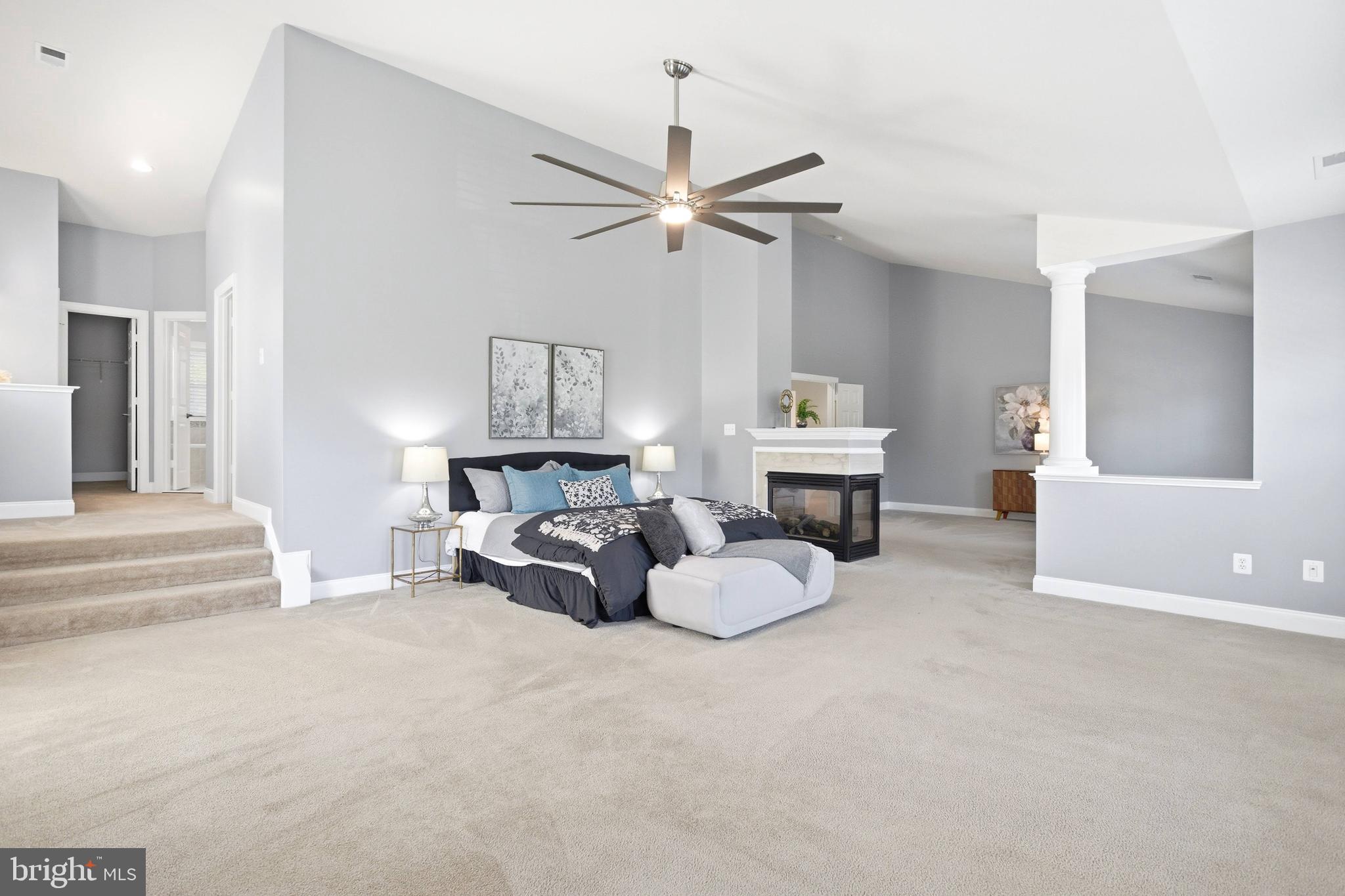 18475 Kerill Road Triangle, VA 22172 - Photo 10 of 99 a spacious bedroom with a bed and a chandelier