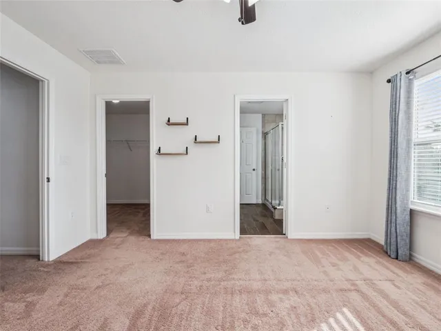 a view of a room with a refrigerator in a room