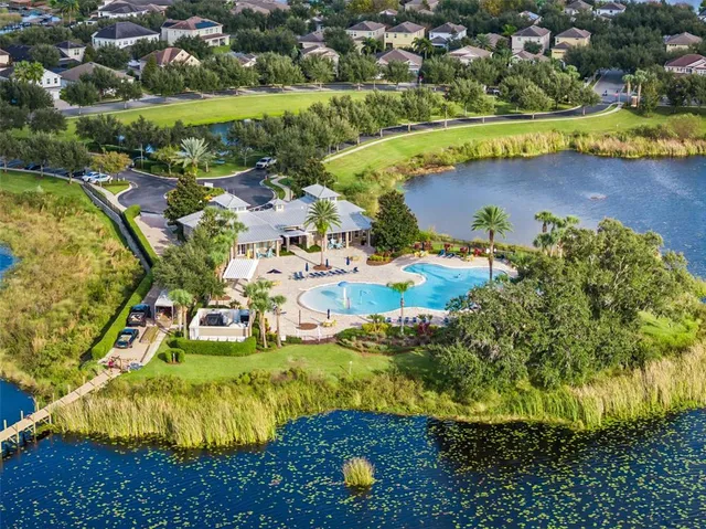 an aerial view of residential houses with outdoor space and swimming pool