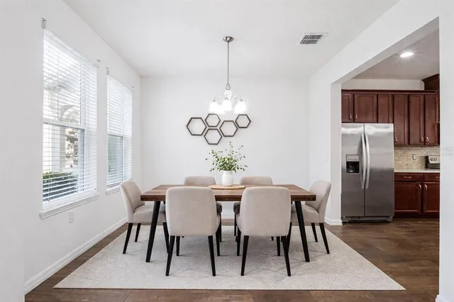 a view of a dining room with furniture window and wooden floor