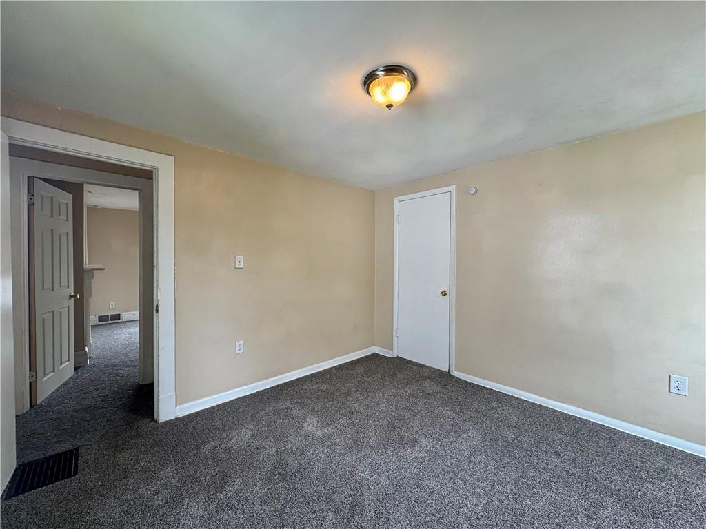 442 Park Street Rochester, PA 15074 - Photo 27 of 31 an empty room with a piano and mirror