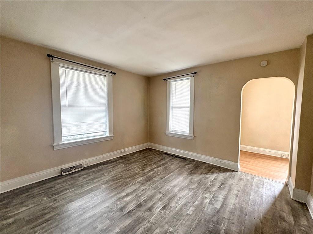 442 Park Street Rochester, PA 15074 - Photo 6 of 31 an empty room with wooden floor and windows
