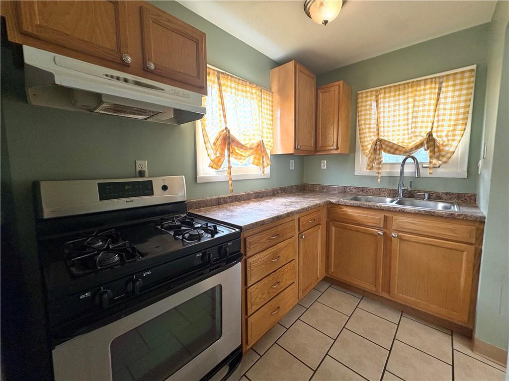442 Park Street Rochester, PA 15074 - Photo 7 of 31 a kitchen with granite countertop cabinets stainless steel appliances and a window