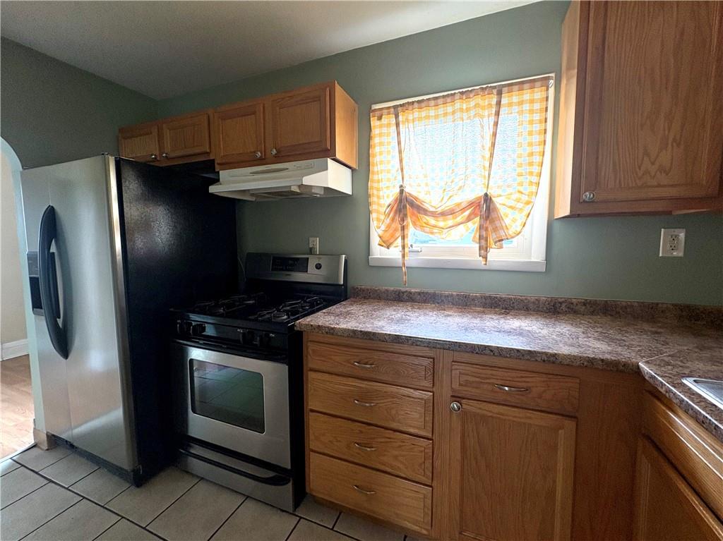 442 Park Street Rochester, PA 15074 - Photo 9 of 31 a kitchen with granite countertop cabinets stainless steel appliances and a window