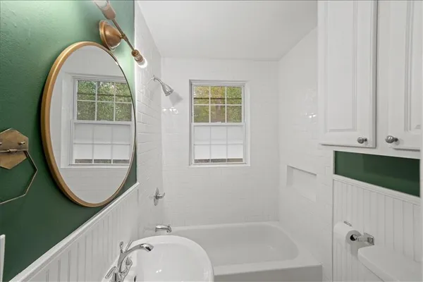 a bathroom with a tub and a window