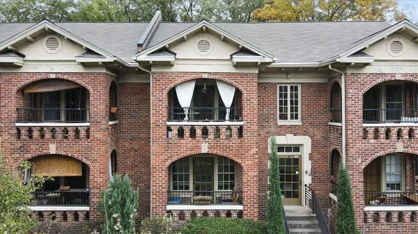 a front view of a house with yard and garage