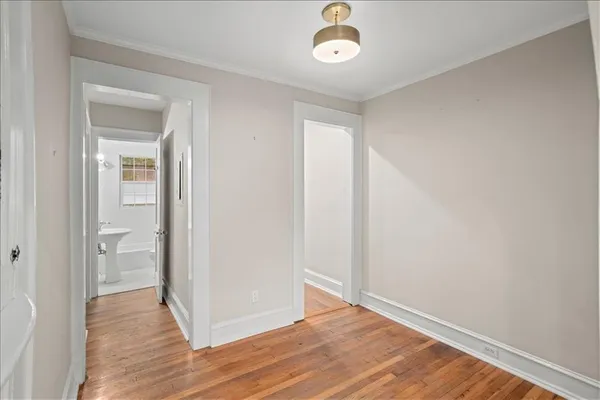 an empty room with wooden floor and a window