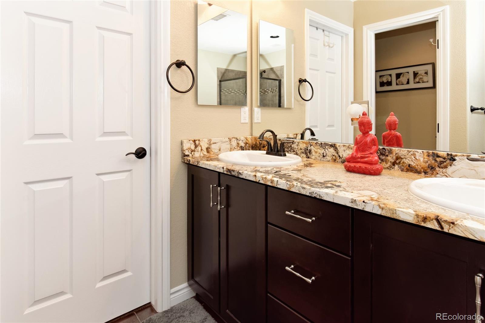 9278 Viaggio Way Highlands Ranch, CO 80126 - Photo 21 of 35 a bathroom with a granite countertop sink and a mirror