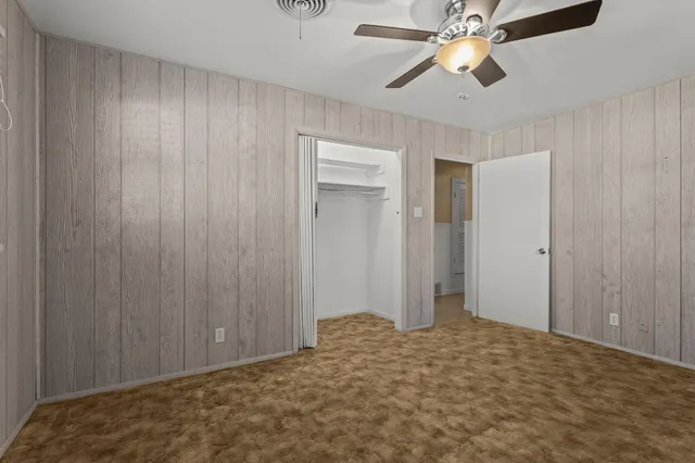 a view of a room with a ceiling fan