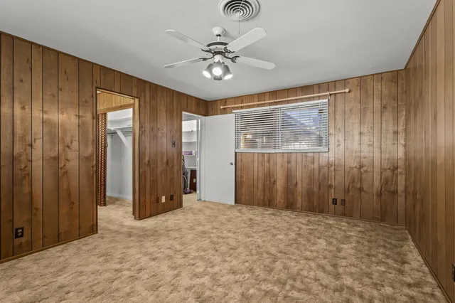 a view of a livingroom with a chandelier fan and closet