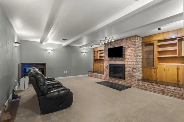 a living room with a fireplace furniture and a flat screen tv