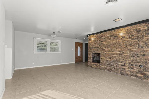 a view of an empty room with a fireplace