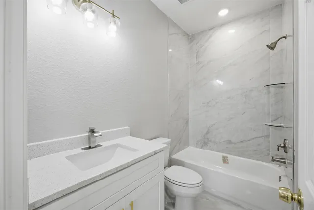 a bathroom with a sink toilet and bathtub