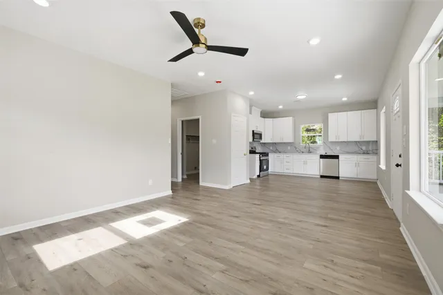a view of a kitchen with a refrigerator and a window