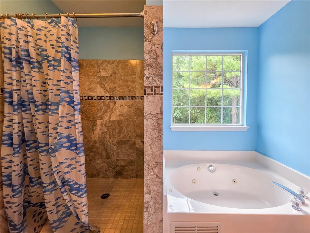 43 Ivy Mist Lane Acworth, GA 30101 - Photo 19 of 58 a bathroom with a bathtub and shower