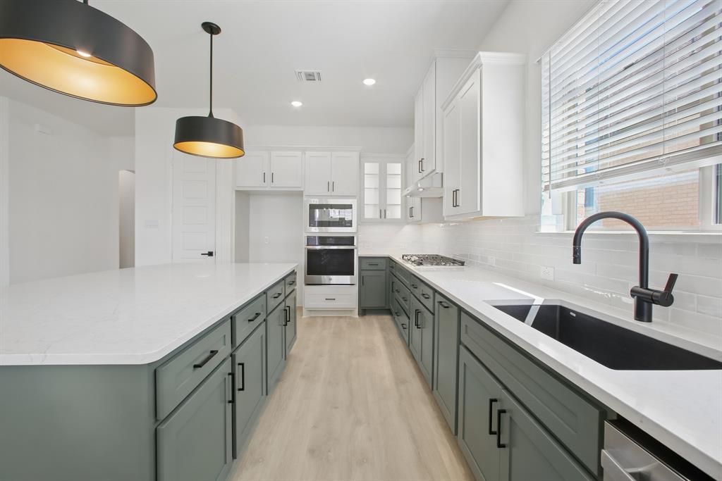 605 Derby Drive Mansfield, TX 76063 - Photo 12 of 13 a kitchen with a sink a counter space cabinets and appliances
