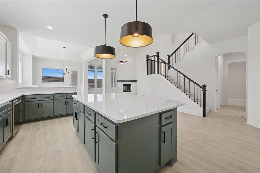 605 Derby Drive Mansfield, TX 76063 - Photo 13 of 13 a kitchen with stainless steel appliances granite countertop a sink a stove and a wooden floors