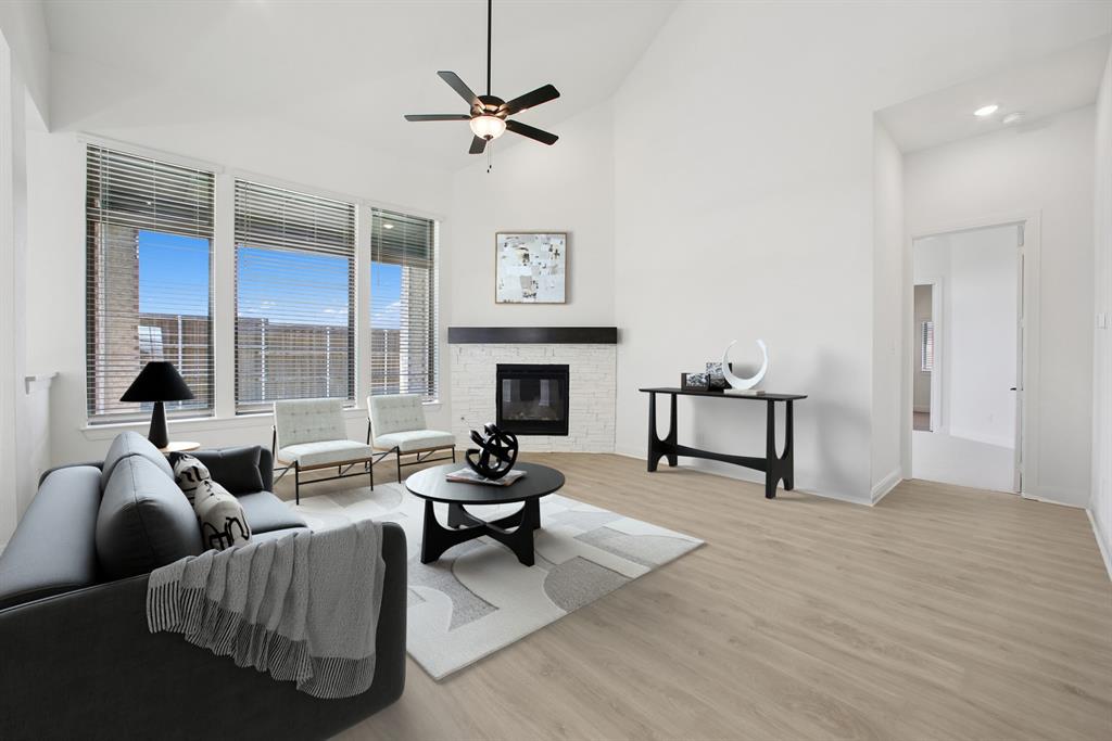 605 Derby Drive Mansfield, TX 76063 - Photo 8 of 13 a living room with furniture and a fireplace